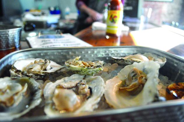 Steamed choice Chesapeake Bay oysters with grilled lemon are seen on a bed of rock salt at Velchoff's Oyster Bar in Palatka on Friday. (CASMIRA HARRISON/Palatka Daily News)