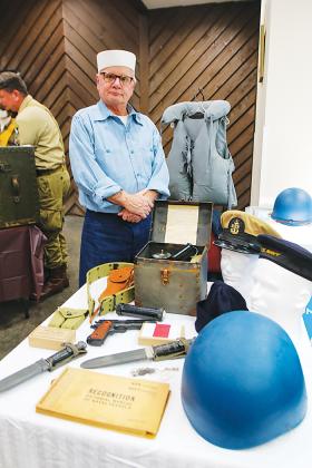 Naval reenactor Rob Matson stands near his naval collection last month at the One Book One Putnam launch at the Palatka Golf Club.