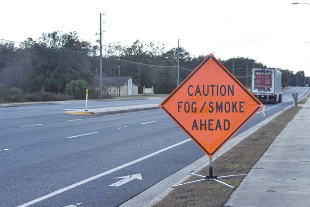 A sign warns drivers of fog and smoke in the area of Francis Church Road and State Road 20 in Palatka on Wednesday, a day after a fire occurred in the area.