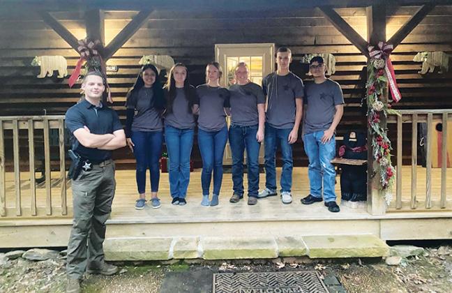 Members of the Putnam County Sheriff’s Office Explorers Post 955 smile in front of their Tennessee cabin last week while at a two-day event.