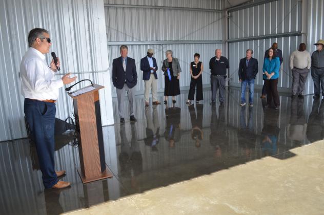 Andrew Holesko, left, CEO and senior planner with aviation engineering and consulting firm Passero Associates, speaks about the the six newly built hangars at the Palatka Municipal Airport on Wednesday. The hangars, which may be followed by two more, are expected to help alleviate the long waiting list for aircraft covered parking space at the airport. CASMIRA HARRISON/Palatka Daily News 