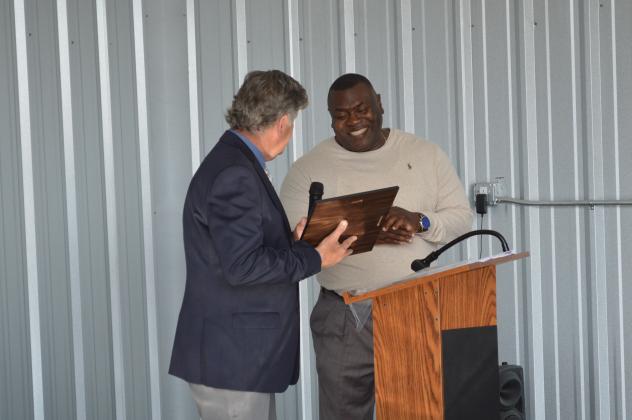 Palatka Municipal Airport Advisory Board Chairman Jud Neufeld, left, bestows a plaque of appreciation to former Palatka mayor Terrill Hill on Wednesday at "Kay" Larkin Field during a ceremony to unveil six new airplane hangars at the site. Hill was honored for his involvement in the airport’s advancement through the years, including his help in implementing the hangar project. CASMIRA HARRISON/Palatka Daily News 