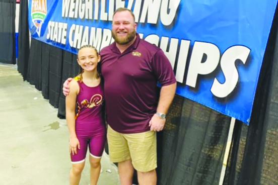 Crescent City’s Emma Wolfe (left) poses with Raiders coach Robert Ripley after finishing ninth place in the FHSAA 1A 101-pound competition in Lakeland on Saturday. (Crescent City Junior-Senior High School Facebook page). Below, Palatka's Camden Posey (Daily News photo)