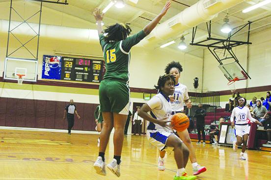 Palatka’s Zy’ria Jones looks to find a way to the basket, while Live Oak Suwannee’s Shadavia Jones goes up to defend her during Thursday night’s District 5-4A girls basketball semifinal matchup won by the Panthers, 41-28, at North Marion High School. (MARK BLUMENTHAL / Palatka Daily News)