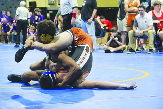Palatka’s Mikade Harvey (top) tries to pin Tocoi Creek’s Mark Coniker during the 138-pound title match. Harvey won by technical fall, 18-3. (COREY DAVIS / Palatka Daily News)