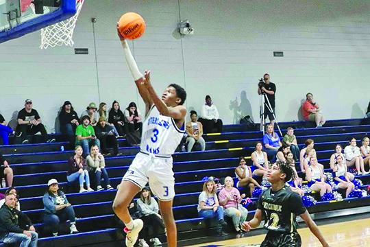 Interlachen’s Jaden Perry goes up for a first-half layup ahead of Ocala Trinity Catholic’s Brandon Haughton during Tuesday night’s District 2-3A Tournament opening-round game. (RITA FULLERTON / Special to the Daily News)