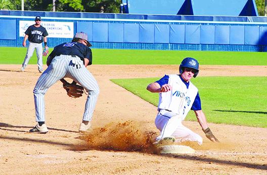 St. Johns River State College’s Michael Furry slides safely into third base as Daytona State third baseman Devon Nowles retrieves the ball during the third inning of Wednesday’s game at Tindall Field. (RITA FULLERTON / Special to the Daily News)