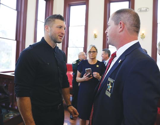 Former NFL quarterback Tim Tebow, left, talks with Putnam County Sheriff Gator DeLoach during a press conference Thursday morning.