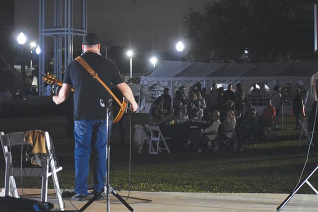 Damion Waters sings and plays the guitar during Friday’s event.