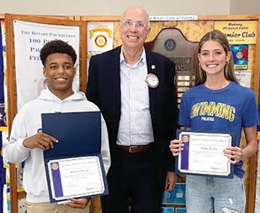 Palatka Junior-Senior High School senior Mikade Harvey, left, Rotarian Robert Mills, center, and senior Ruby Doran gather for a photo after the Rotary Club of Palatka honored the students for their efforts in academics and athletics.