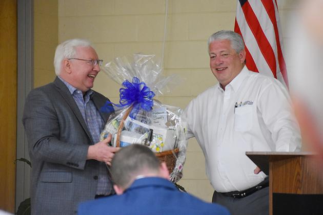 Mark Litten, right, the Putnam County Chamber of Commerce's vice president of economic development, presents a gift basket to Ron Starner who spoke Thursday during a Putnam County Economic Development Council meeting.