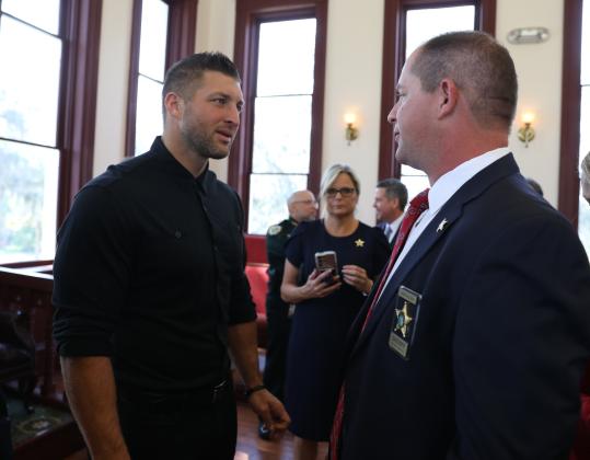 Courtesy of the Putnam County Sheriff's Office. Putnam County Sheriff Gator DeLoach talks to former University of Florida football player Tim Tebow during a press conference about the Florida Inter-Agency Child Exploitation and Person Trafficking Task Force.