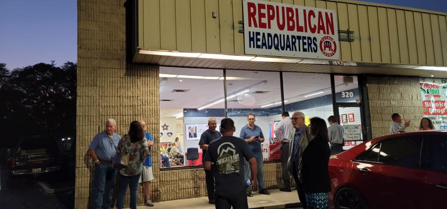 Non-members of the Putnam County Republican Executive Committee stand outside the meeting after the meeting, seen occurring in the background, was closed to non-members on Tuesday. 