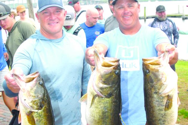 Jason Caldwell and Lee Stalvey show their three 9-pound largemouth bass that led to their win in the Roberts-Williams Invitational Bass Tournament on Saturday and Sunday at Palatka City Dock. (GREG WALKER / Daily News correspondent)