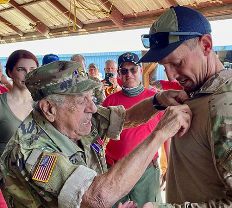 Courtesy of the Round Canopy Parachuting Team-USA. Vince Speranza, World War II veteran paratrooper of the 101st Airborne Division pins RCPT-USA jump wings on a student who completed a five-day Round Canopy parachute training course in preparation for jumps into Normandy, France and airshows in the United States later this year.