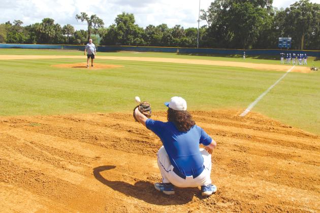 Bill Swaggerty took a trip down memory lane at the Azalea Bowl baseball field in Palatka. Here, he threw his famous cutter fastball to JV catcher Morgan Wiggs.