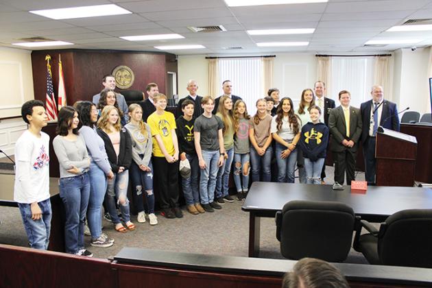 Students from advanced civics classes at Palatka Junior-Senior High School smile for a photo with the judges, County Clerk Matt Reynolds, Putnam County Sheriff Gator DeLoach and Sheriff’s Office general counsel Alex Sharp.
