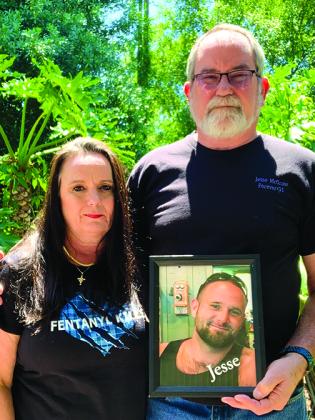 Sherry and Rick Mills of Palatka hold a picture of their son, Jesse McGraw, who died Oct. 4, 2021, in Knoxville, TN, from a fentanyl-laced drug overdose.