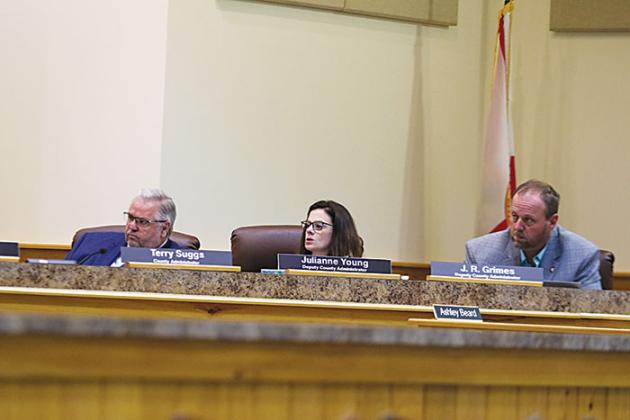 From left, County Administrator Terry Suggs, Deputy County Administrator Julianne Holmes and Deputy County Administrator J.R. Grimes listen during a Board of County Commissioners meeting Tuesday morning.