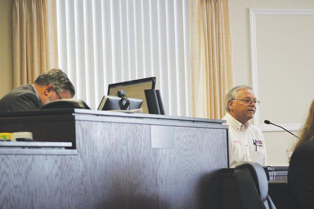 Supervisor of Elections Charles Overturf III, right, testifies while Judge Kenneth Janesk, left, takes notes during a hearing in the effort to recall Crescent City Commissioner Cynthia Burton.