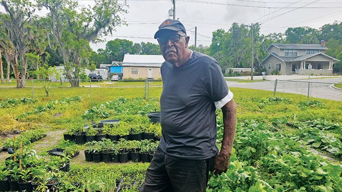 SHALISHA BYNOE/Palatka Daily News   Morris Alston stands in the community garden he maintains at the intersection of River and 12th streets in Palatka.