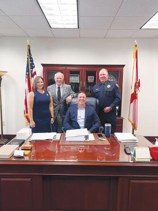 Welaka Events Committee Chairwoman Courtney Desouza, left, Mayor Jamie Watts, seated, and Chief of Police Mike Porath, right, meet with a state legislator in Tallahassee two days before Rural Counties Day on Wednesday.