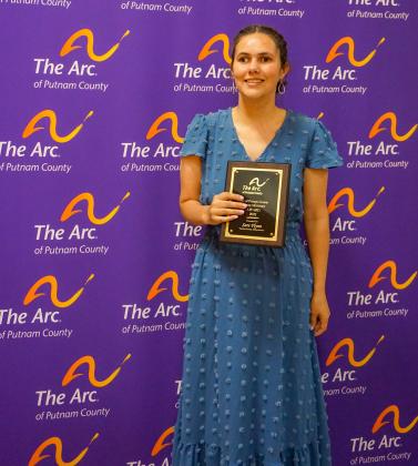 Arc consumer Sara Flynn smiles with the Eddie Mooney Award that she won during Thursday's ceremony. 