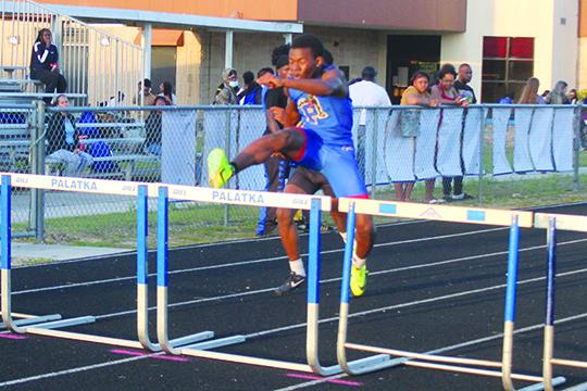Palatka’s Derick Holland clears a hurdle en route to winning the county 400-meter intermediate hurdles championship on March 31. (MARK BLUMENTHAL / Palatka Daily News)