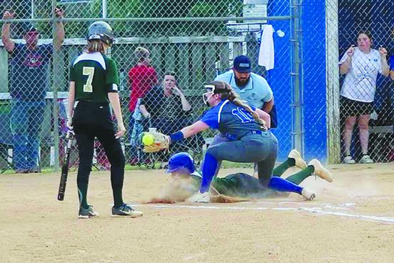 St. Joseph Academy’s Zariyah Turner slides into home plate safely ahead of the throw to Peniel Baptist Academy pitcher Lexi Peacock as Turner’s teammate, Madeleine Mullins (7), watches. (RITA FULLERTON / Special to the Daily News)