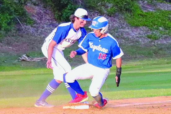 Keystone Heights’ Aiden Screen (18) gets into third base safely as Palatka third baseman Jace Akers looks to get the tag on him during Tuesday’s game at the Azalea Bowl. (RITA FULLERTON / Special to the Daily News)