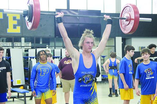 With teammate Ishmael Foster watching behind him, Palatka 154-pounder Braxton Anderson competes in the clean and jerk at the Putnam County Championship meet in February. Foster and Anderson are two of the county’s five competitors at Saturday’s FHSAA 1A championship. (COREY DAVIS / Palatka Daily News)