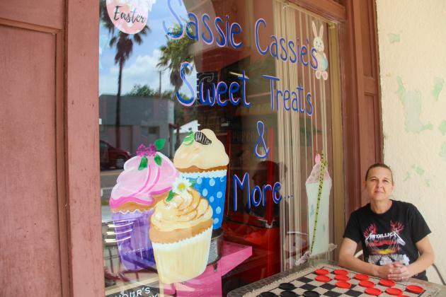 SARAH CAVACINI/Palatka Daily News. Cassie Harrig sits outside her shop, Sassie Cassie's Sweet Treats & More, on Thursday. 