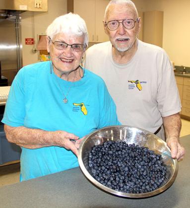 Janet and Bob Sikes, volunteers when the Bostwick Blueberry Festival started in 1997, are at the Bostwick Community Center on Monday to help sort and bag the blueberries for this year’s festival. -- TRISHA MURPHY/Palatka Daily News