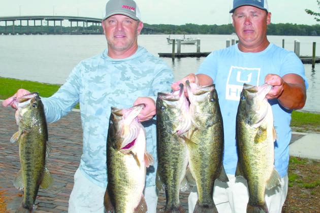 Jason Caldwell and Lee Stalvey hold up their winning fish at the Messer’s Invitational Bass Tournament at Palatka, (GREG WALKER / Daily News correspondent)