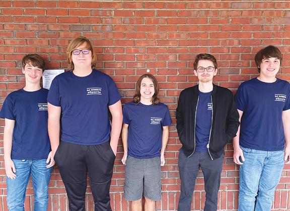 The Q.I. Roberts Junior-Senior High School esports team placed first in a national championship this month under the guidance of their coach and computer science teacher, Chris Cantrell, second from right.