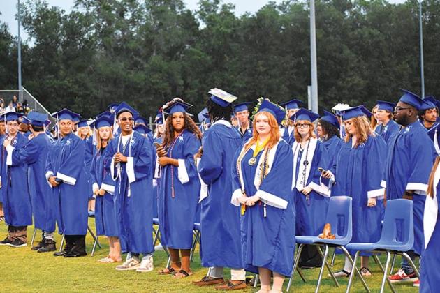 Interlachen Junior-Senior High School graduates stand during the beginning of the school’s commencement ceremony Tuesday evening.
