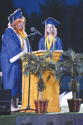 Top Scholar Peyton Alexander, left, addresses the class of 2023 during Interlachen’s commencement ceremony Tuesday evening while Class President Aryaunnah Irizarry listens. 