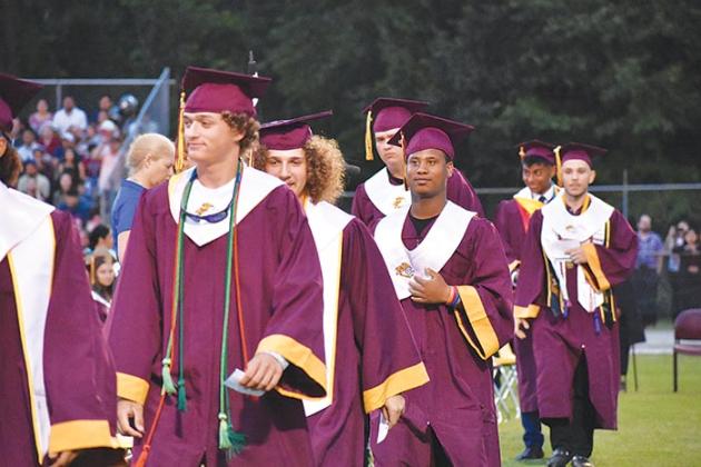Crescent City Junior-Senior High School graduates line up to receive their diplomas during the school's commencement ceremony Thursday evening.