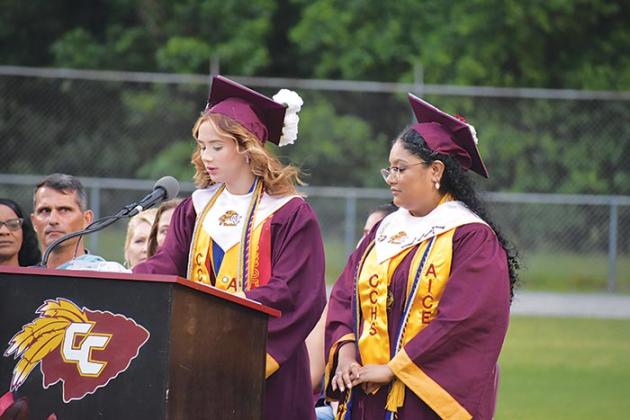 Summer Crosby, left, reads her dedication to the class of 2023 after Violetta Salazar-Barrientos, right, read her dedication during the Crescent City Junior-Senior High School commencement ceremony Thursday evening.