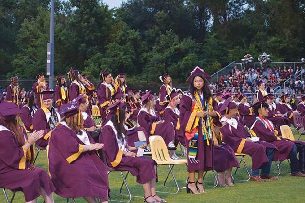 Some Crescent City Junior-Senior High School graduates stand to be recognized as honor graduates during the school's commencement ceremony Thursday evening.
