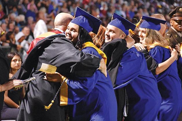 BRANDON D. OLIVER/Palatka Daily News  Graduates and teachers hug each other as the departing seniors prepare to receive their diplomas.