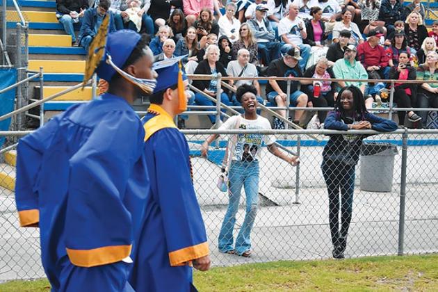 BRANDON D. OLIVER/Palatka Daily News  A spectator at the Palatka Junior-Senior High School commencement ceremony cheers enthusiastically for her loved one who walks to his seat.