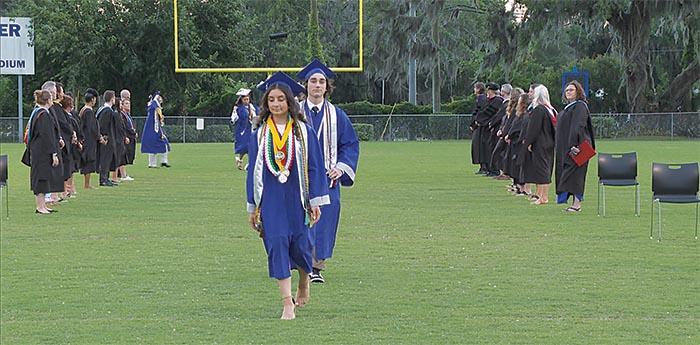 Photo courtesy of the Putnam County School District   Q.I. Roberts Junior-Senior High School graduates march onto the field at Veterans Memorial Stadium in Palatka for their commencement ceremony Saturday evening.