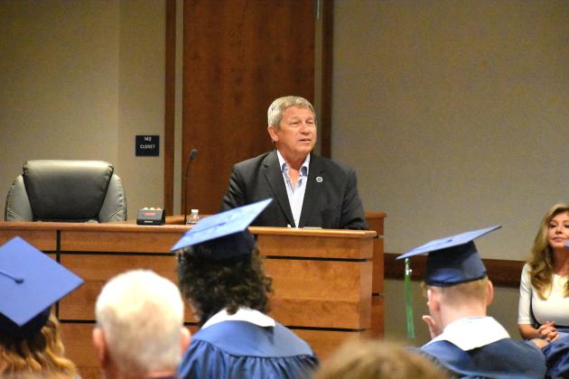Superintendent Rick Surrency speaks during the Putnam Virtual School graduation ceremony while Principal Mary Wood listens. 