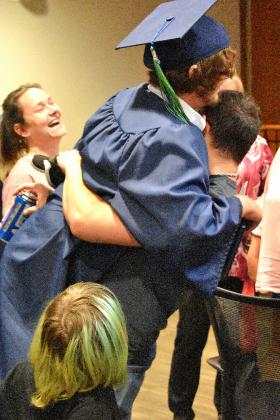 One of Putnam Virtual School graduate Coby Fletcher is hoisted in the air in celebration after the school's commencement ceremony Monday evening.