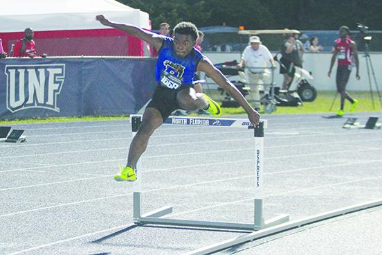 Palatka’s Derick Holland clears a hurdle as he competes in his heat of the 400-meter intermediate hurdles, finishing in 59.72 seconds. (MARK BLUMENTHAL / Palatka Daily News)