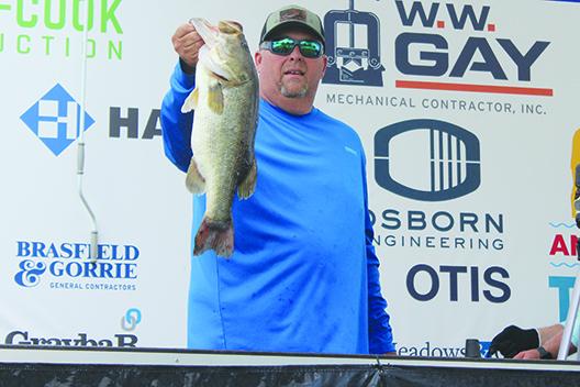 David McIntyre of Lake City shows off his 6.94-pound bass catch that earned he and partner Michael Johnson the biggest catch of the day honors Friday. (MARK BLUMENTHAL / Palatka Daily News)