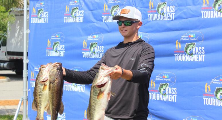Parker Stalvey shows off his two 5-pounders he and step-fahter Joshua Potter caught in taking 10th place at the Wolfson Children’s Hospital Bass Tournament last Saturday. (MARK BLUMENTHAL / Palatka Daily News)