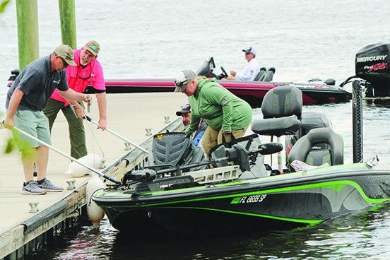 A boat is brought into the dock after a day of competition Thursday in the Lads and Lasses Tournament on the St. Johns River. (CASMIRA HARRISON / Palatka Daily News)