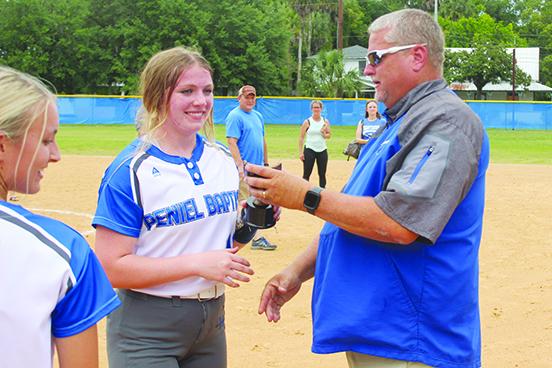 Peniel Baptist Academy's Lexi Peacock receives the Most Outstanding Player honor from head coach Jeff Hutchins after pitching and hitting the Warriors to the Florida Christian Athletic League championship Saturday at Rotary Park against Gainesville Countryside Christian, 10-0. (MARK BLUMENTHAL / Palatka Daily News)
